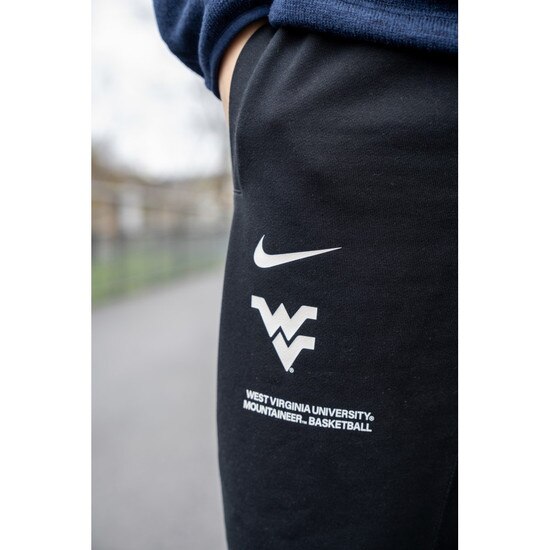 Close up of the Flying WV Logo over local verbiage screen print at upper right thigh on the Black WVU Nike pants