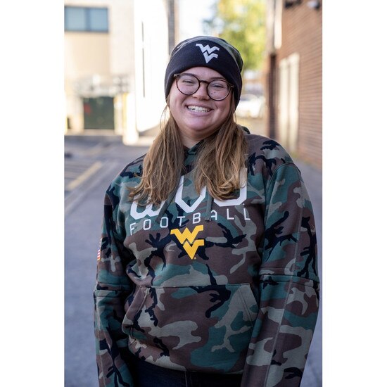 Model wearing Camo Nike WVU winter beanie with a white Flying WV on the of the front cuff